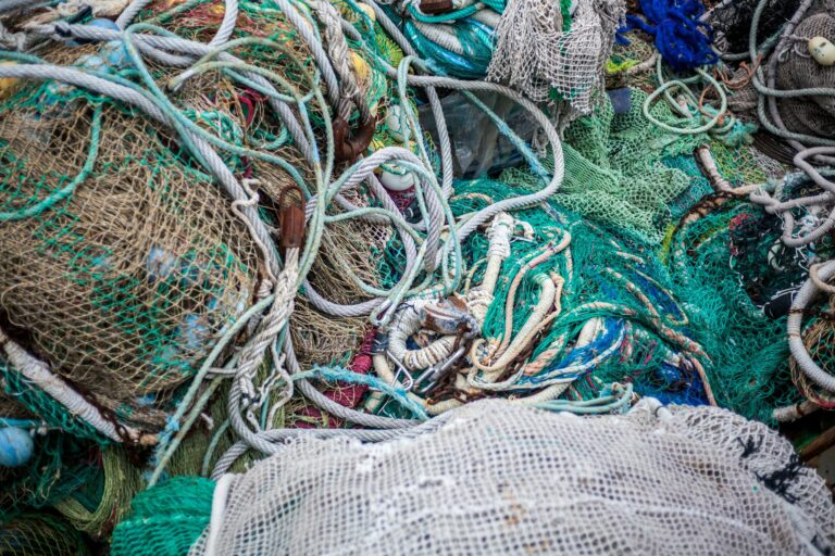 Close-up of tangled fishing nets and ropes displaying marine textures and colors.