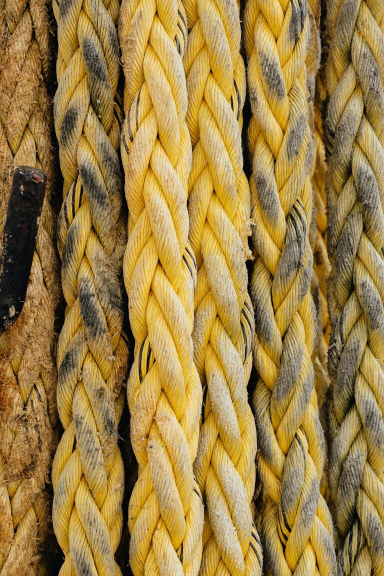 Detailed texture of thick yellow braided ropes, perfect for background use in various projects.