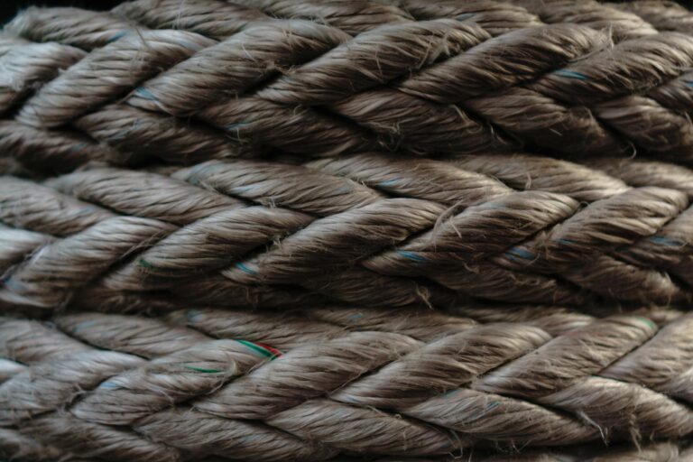 Macro shot showcasing the intricate texture and fibers of braided brown rope.